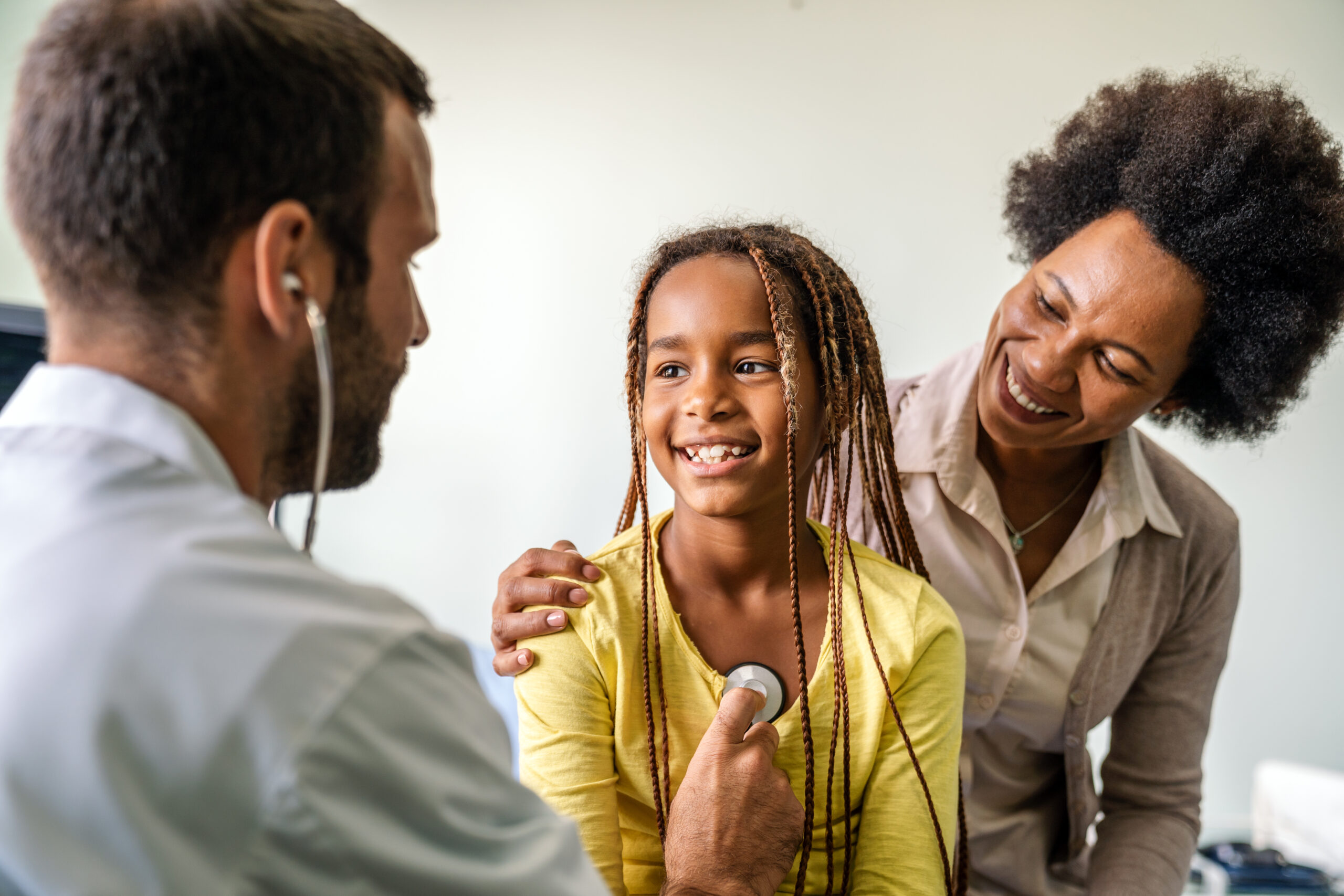 A doctor meeting with a mother and daughter